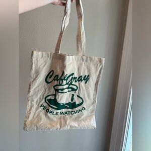 Conan gray Cafe gray people watching green and tan coffee tote bag.